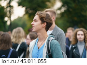 Moscow, Russia - September 5, 2019: Portrait of young man visiting the city festival in the Gorky park. A crowd of youth around him. Blurred background. Редакционное фото, фотограф YuryKara / Фотобанк Лори