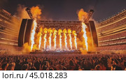 Musicians playing live music for a stadium crowd with pyrotechnics. Стоковое AI-видео, аниматор Юрий Поздников / Фотобанк Лори