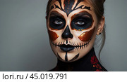 Scary Halloween makeup on a woman's face in the form of a skull, a corpse. Halloween Party. AI generated. Стоковое AI-изображение, AI-художник Ольга Симонова / Фотобанк Лори