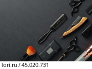 An Assortment of Professional Hairdressing Tools Laid Out on a Dark Surface. Стоковое фото, фотограф Сергей Толмачёв / Фотобанк Лори