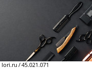 An Assortment of Professional Hairdressing Tools Laid Out on a Dark Surface. Стоковое фото, фотограф Сергей Толмачёв / Фотобанк Лори