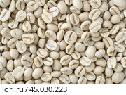 Close up view of unroasted green coffee beans filling the image. Стоковое AI-изображение, AI-художник Иван Рябоконь / Фотобанк Лори