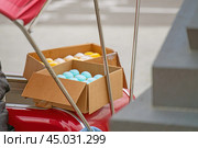 Vibrant display of colorful ice cream in open boxes, showcasing a delightful array of flavors. The enticing sight promises a refreshing treat, perfect for a warm day. Стоковое фото, фотограф Татьяна Степанищева / Фотобанк Лори