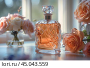 Elegant glass perfume bottle standing near peach roses on dressing table. Стоковое AI-изображение, AI-художник Иван Рябоконь / Фотобанк Лори