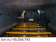 GRAN CANARIA, CANARY ISLANDS, SPAIN - AUGUST 06, 2024: The small Chapel of San Juan Bautista (Ermita de San Juan Bautista). The chapel is partially carved directly into the rock. Guayadeque gorge. Редакционное фото, фотограф Sergey Kohl / Фотобанк Лори