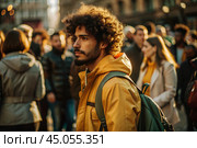Portrait of a curly-haired mulatto traveler in a yellow jacket and with a backpack in the city. Traveling alone is a lifestyle. A young tourist is enjoying his autumn vacation. Стоковое AI-изображение, AI-художник Photojuli / Фотобанк Лори