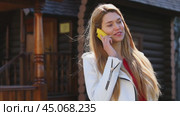Calling by Phone. Happy young woman talking on cell phone. Стоковое видео, видеограф Андрей Аркуша / Фотобанк Лори