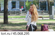 Calling by Phone. Happy beautiful blonde woman talking on cell phone. Стоковое видео, видеограф Андрей Аркуша / Фотобанк Лори