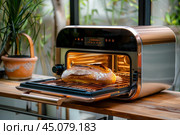 Modern technology convection oven baking delicious bread in the kitchen. Стоковое AI-изображение, AI-художник Иван Рябоконь / Фотобанк Лори