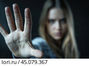Young woman making stop gesture with hand. Стоковое AI-изображение, AI-художник Иван Рябоконь / Фотобанк Лори
