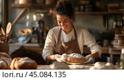 A young woman bakes fresh bread in a rustic kitchen filled with natural light during the late morning. Стоковое AI-изображение, AI-художник Сергей Толмачёв / Фотобанк Лори