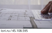 The designer draws with a compass and ruler on the drawing. Стоковое видео, видеограф Igor Skripachev / Фотобанк Лори