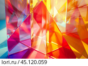 Light refracting through colorful translucent triangular shapes. Стоковое AI-изображение, AI-художник Иван Рябоконь / Фотобанк Лори