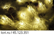 Transparent skeletons glowing yellow, close-up. Transform your space with a whimsical garland featuring glowing skeleton skulls and bones, perfect for Halloween festivities and ambiance. Horror theme. Стоковое видео, видеограф Юлия Петровская / Фотобанк Лори