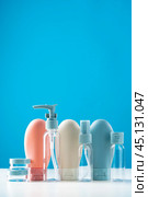 Variety of travel-sized containers displayed against a bright blue background. Стоковое фото, фотограф Сергей Толмачёв / Фотобанк Лори