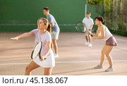 Sportive woman in shorts and t-shirt playing frontenis on court. Стоковое фото, фотограф Яков Филимонов / Фотобанк Лори