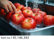 Человек моет красные спелые яблоки под струей воды. Стоковое AI-изображение, AI-художник Щеголева Ольга / Фотобанк Лори