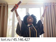 A happy Black graduate student has received a diploma of higher education and an MBA degree from an college. Стоковое фото, фотограф Ярославский Максим / Фотобанк Лори