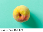peach on a blue wooden background. Стоковое фото, фотограф Сергей Толмачёв / Фотобанк Лори