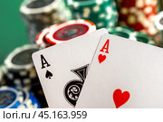 Cards and chips for poker on green table. Стоковое фото, фотограф Сергей Толмачёв / Фотобанк Лори