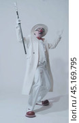 Vertical video of dancing clown. An elderly man in a white coat and hat with walking stick. Стоковое видео, видеограф Сергей Пристяжнюк (Serg Zastavkin) / Фотобанк Лори
