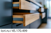 Sleek kitchen drawers with wooden fronts and modern design, AI. Стоковое AI-изображение, AI-художник Сергей Старуш / Фотобанк Лори