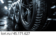 Car Tires on Black Background. Стоковое AI-изображение, AI-художник Решат Алиев / Фотобанк Лори