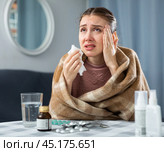 Woman with fever symptoms sitting at home. Стоковое фото, фотограф Яков Филимонов / Фотобанк Лори