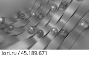 Silver spheres rolling down metallic ribbons. Стоковое видео, видеограф Данил Руденко / Фотобанк Лори