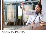 Professional woman checks the wine at factory. Стоковое фото, фотограф Татьяна Яцевич / Фотобанк Лори