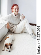 Young Woman Drinking hot coffee at white room. Стоковое фото, фотограф Гладских Татьяна / Фотобанк Лори