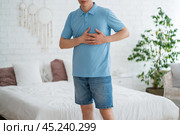Heart attack, man with chest pain suffering at home, myocardial infarction. Стоковое фото, фотограф Станислав Тарко / Фотобанк Лори