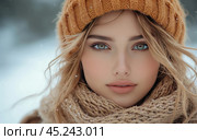 Portrait of a young woman on a winter background. She is wearing a warm knitted mustard-colored hat and scarf, her light hair is slightly fluttering in the wind, and her face shows tender rosy cheeks from the cold. The girl's eyes are bright blue and attract attention. The photo conveys a feeling of winter freshness and tranquility. Стоковое AI-изображение, AI-художник Анна Кривицкая / Фотобанк Лори