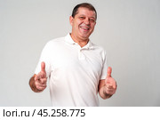 An older man smiling and reaching out with both hands. Стоковое фото, фотограф Сергей Толмачёв / Фотобанк Лори