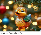 Clumsy duckling on a Christmas tree, bright Christmas tree toy. New Year's decor. Festive New Year's atmosphere. Стоковое AI-изображение, AI-художник Сергей Елизарьев / Фотобанк Лори