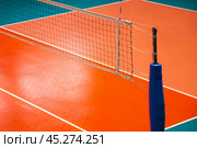 Scene of professional volleyball court with net in sporty gym indoors. Sport background, volleyball courts in sport hall. Concept of team game success, healthy sporty lifestyle. Copy ad text space. Стоковое фото, фотограф Aleksandr Golubev / Фотобанк Лори
