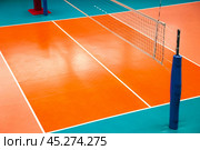 Professional volleyball court with net in sporty gym indoor, top view. Sport background, volleyball courts in sport hall. Team game success, healthy sporty lifestyle concept. Copy ad text space banner. Стоковое фото, фотограф Aleksandr Golubev / Фотобанк Лори
