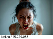 Screaming, hate, rage. Crying emotional angry caucasian woman screaming, yelling on gray studio background. Emotional, young face. Female close up portrait. Human emotions, facial expression concept. Стоковое AI-изображение, AI-художник Sergey Grishin / Фотобанк Лори