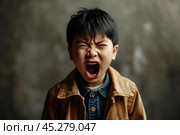Portrait of Asian angry, sad and cry little boy on dirty grey color background, The emotion of a child when tantrum and mad, expression grumpy emotion, yelling, shouting. Kid emotional control concept. Стоковое AI-изображение, AI-художник Sergey Grishin / Фотобанк Лори