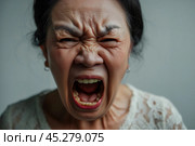 asian Elder senior woman with angry, mad, depressive and furious face expression looking for fight isolated over grey dirty background. Mature female yelling with closed eyes, annoyed and frustrated. Стоковое AI-изображение, AI-художник Sergey Grishin / Фотобанк Лори