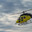 Transport helicopter hovers over mountain terrain at sunset, dramatic lighting highlights sleek design and rotor blades in motion. Стоковое фото, фотограф Владимир Ендовицкий / Фотобанк Лори