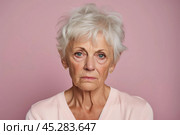 Unamused sad miserable mature short grey haired caucasian woman wearing pink blouse, frowns face with dissatisfaction, sulks troubled as someone hurt her feelings. Indoor studio shot isolated on pink. Стоковое AI-изображение, AI-художник Sergey Grishin / Фотобанк Лори