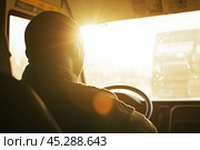 Driver turns steering wheel of truck, bus at sunset time. Skilled chauffeur drives lorry to deliver freight. Cargo shipping service. Drives Journey. Drivers silhouette against a vivid sundown. Travel. Стоковое AI-изображение, AI-художник Марина Демидюк / Фотобанк Лори
