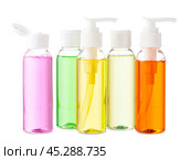 Variety of colorful personal care bottles and grooming accessories arranged on a white surface. Стоковое фото, фотограф Сергей Толмачёв / Фотобанк Лори