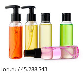 Variety of colorful personal care bottles and grooming accessories arranged on a white surface. Стоковое фото, фотограф Сергей Толмачёв / Фотобанк Лори