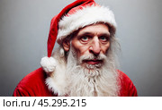 Santa Claus, visibly tired from festive season duties, candid image capturing holiday weariness, slump indicative of exhaustion after spreading joy. Стоковое AI-изображение, AI-художник Павел Муравьев / Фотобанк Лори