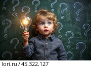 Development and education of children. A thoughtful boy on a dark background with a light bulb and question marks . Brainstorming and the concept of an idea. Стоковое AI-изображение, AI-художник Photojuli / Фотобанк Лори