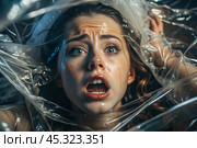 The girl is wrapped in cellophane or a bag. The girl is suffocating. Plastic pollution of the planet. Environmental hazard. Reducing the reuse of plastic. Recycling. The concept of garbage. Стоковое AI-изображение, AI-художник Photojuli / Фотобанк Лори