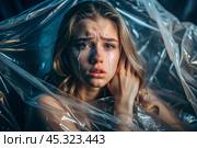 The girl is wrapped in cellophane or a bag. The girl is suffocating. Plastic pollution of the planet. Environmental hazard. Reducing the reuse of plastic. Recycling. The concept of garbage. Стоковое AI-изображение, AI-художник Photojuli / Фотобанк Лори