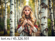 A beautiful girl in a traditional Russian folk shawl in a summer birch grove. The portrait symbolizes the traditions and beauty of the Russian people. Стоковое AI-изображение, AI-художник Photojuli / Фотобанк Лори